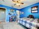 Bright blue bedroom featuring functional desk, closet, and stylish decor at 1930 Knollcrest Dr, Clermont, FL 34711