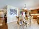 Dining room with glass table and seating for six, with access to the kitchen and front entryway at 1930 Knollcrest Dr, Clermont, FL 34711