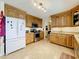 Kitchen featuring tile floor, light wood cabinets, and stainless steel appliances at 1930 Knollcrest Dr, Clermont, FL 34711