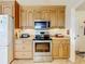 Well-lit kitchen featuring stainless steel appliances, granite countertops, and beautiful wooden cabinetry at 1930 Knollcrest Dr, Clermont, FL 34711
