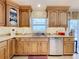 Kitchen with granite counters, light wood cabinets, stainless steel appliances, and under cabinet lighting at 1930 Knollcrest Dr, Clermont, FL 34711