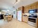 Open concept kitchen with stainless steel appliances and a view of the dining and living areas at 1930 Knollcrest Dr, Clermont, FL 34711