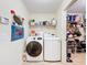 Laundry room with tile floors, a washer, dryer, shelving and attached closet at 1930 Knollcrest Dr, Clermont, FL 34711