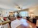 Open living room featuring hardwood floors, neutral decor, and pool views through large window at 1930 Knollcrest Dr, Clermont, FL 34711