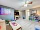 Spacious living room with a stone fireplace and lots of natural light at 1930 Knollcrest Dr, Clermont, FL 34711