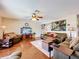 Spacious living room featuring hardwood floors, plush seating, and a large entertainment center at 1930 Knollcrest Dr, Clermont, FL 34711