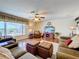 Comfortable living room featuring hardwood floors and access to the pool area at 1930 Knollcrest Dr, Clermont, FL 34711