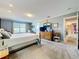 Spacious main bedroom features a neutral color palette, plush carpeting, and lots of natural light at 1930 Knollcrest Dr, Clermont, FL 34711