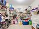 Walk-in pantry features wire shelves stocked with food and household items on tile floor at 1930 Knollcrest Dr, Clermont, FL 34711