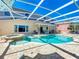 Backyard features a screened-in pool and spa, along with patio and outdoor seating at 1930 Knollcrest Dr, Clermont, FL 34711