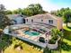 Backyard view of home featuring a screened-in pool, patio, and manicured landscaping at 1930 Knollcrest Dr, Clermont, FL 34711