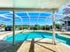 Screened-in pool and spa area with patio and clear blue sky above at 1930 Knollcrest Dr, Clermont, FL 34711