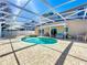 Screened-in pool area features a jacuzzi and covered patio with outdoor seating at 1930 Knollcrest Dr, Clermont, FL 34711