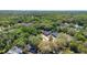 This aerial view captures a well-situated home in a neighborhood with mature trees and landscaping at 2074 King Richards Ct, Orange City, FL 32763