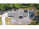 This is an aerial view of the home, showing the roof, solar panels, pool, and surrounding yard at 2074 King Richards Ct, Orange City, FL 32763