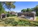 The beautiful backyard features a screened-in pool, lush green grass, and a handy storage shed at 2074 King Richards Ct, Orange City, FL 32763