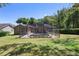 A spacious, green backyard features a screened in pool, perfect for relaxing and entertaining at 2074 King Richards Ct, Orange City, FL 32763