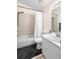 Functional bathroom with tub and shower combo, toilet, and single sink vanity with modern fixtures at 2074 King Richards Ct, Orange City, FL 32763