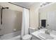 Functional bathroom with tub and shower combo, toilet, and single sink vanity, illuminated by modern lighting at 2074 King Richards Ct, Orange City, FL 32763