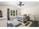 Cozy bedroom features ceiling fan, ensuite window and neutral colors at 2074 King Richards Ct, Orange City, FL 32763