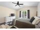 Comfortable bedroom with ceiling fan, stylish rug, and an ensuite door to the backyard at 2074 King Richards Ct, Orange City, FL 32763