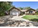 Charming home featuring a two-car garage, American flag, and beautifully landscaped front yard at 2074 King Richards Ct, Orange City, FL 32763