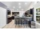 Open kitchen with bar seating, stainless appliances, and lots of natural light at 2074 King Richards Ct, Orange City, FL 32763