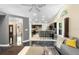 Modern kitchen with dark cabinetry, stainless steel appliances, and breakfast bar seating at 2074 King Richards Ct, Orange City, FL 32763
