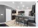 Kitchen with breakfast bar, matching cabinetry, stainless steel refrigerator and modern lighting at 2074 King Richards Ct, Orange City, FL 32763