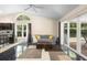 Bright living room with a vaulted ceiling, large windows, and sliding glass doors to the outdoor patio at 2074 King Richards Ct, Orange City, FL 32763