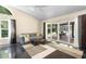Sunlit living room with comfortable seating, sliding doors to outdoor area, and modern flooring at 2074 King Richards Ct, Orange City, FL 32763