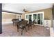 Outdoor patio area with comfortable seating and a sliding glass door with access to the home's interior at 2074 King Richards Ct, Orange City, FL 32763