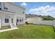 Backyard with a white fence, green grass, and a patio, ideal for outdoor entertaining at 212 Ficus St, Celebration, FL 34747