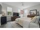 Bright bedroom with a ceiling fan, windows, and hardwood floors at 212 Ficus St, Celebration, FL 34747
