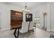 Bright dining room with wood table, stylish chandelier, and a large window at 212 Ficus St, Celebration, FL 34747