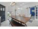 Bright dining room with wood table, stylish chandelier, and an adjacent blue accent room at 212 Ficus St, Celebration, FL 34747