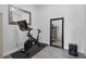 Exercise room featuring a Peloton exercise bike, a workout mat, and a large mirror at 212 Ficus St, Celebration, FL 34747
