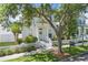 Charming two-story home featuring a welcoming front porch, blue door, and a well-maintained picket fence at 212 Ficus St, Celebration, FL 34747