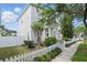 Charming two-story home featuring a welcoming front porch and a well-maintained picket fence and sidewalk at 212 Ficus St, Celebration, FL 34747