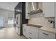 Chic kitchen area featuring stainless steel appliances, herringbone backsplash, and ample cabinetry at 212 Ficus St, Celebration, FL 34747