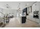 Open-concept kitchen with island, stainless appliances, custom cabinets, and adjoining living room at 212 Ficus St, Celebration, FL 34747