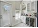 Bright kitchenette featuring custom cabinets, wine storage, beverage cooler, and beverage station at 212 Ficus St, Celebration, FL 34747