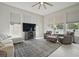 Bright and airy living room with large windows, neutral tones, and comfortable seating at 212 Ficus St, Celebration, FL 34747