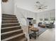 Cozy living room with lots of natural light, comfortable seating, and a carpeted staircase at 212 Ficus St, Celebration, FL 34747
