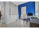 Bright office featuring blue walls, a large bookcase with ladder, and a work desk at 212 Ficus St, Celebration, FL 34747