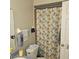 This bathroom features a patterned shower curtain, toilet and grey walls at 2130 Cascades Blvd # 108, Kissimmee, FL 34741