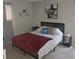 This cozy bedroom has a large bed with a wooden headboard and neutral walls at 2130 Cascades Blvd # 108, Kissimmee, FL 34741