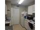 View of kitchen area and appliance with white cabinets and tile floor at 2130 Cascades Blvd # 108, Kissimmee, FL 34741