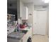 View of kitchen area and appliances with white cabinets, countertop, and tile floor at 2130 Cascades Blvd # 108, Kissimmee, FL 34741