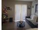 Cozy living room with tile flooring, neutral paint, and ample natural light at 2130 Cascades Blvd # 108, Kissimmee, FL 34741